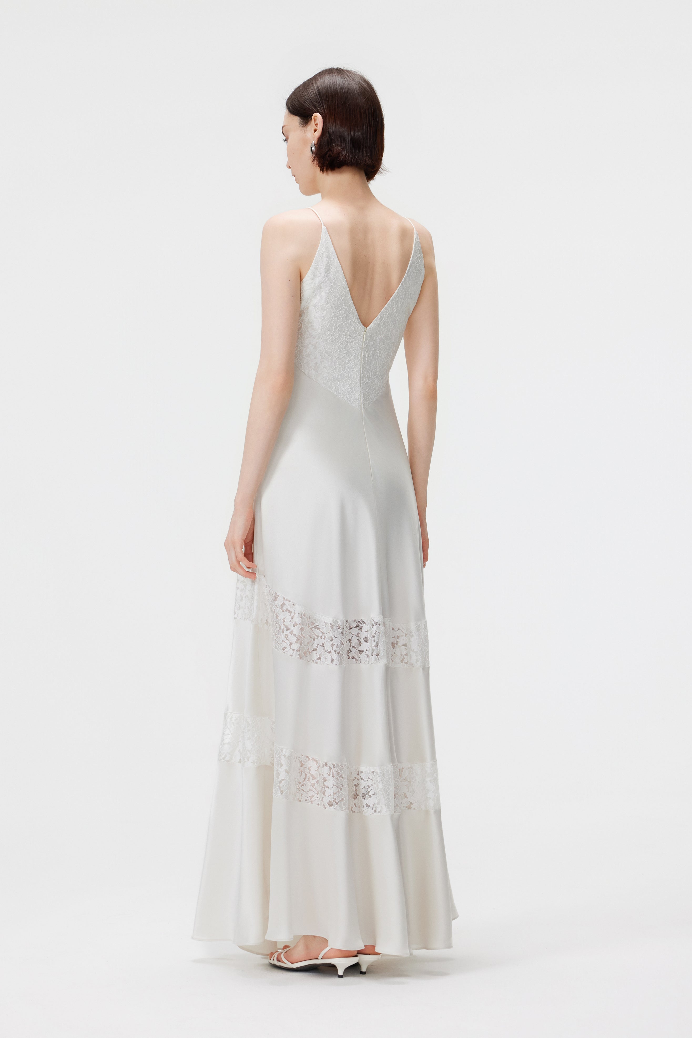 Full-length back view of the Kaia dress in Pearl, highlighting the elegant V-back design and the flared, floor-length train.