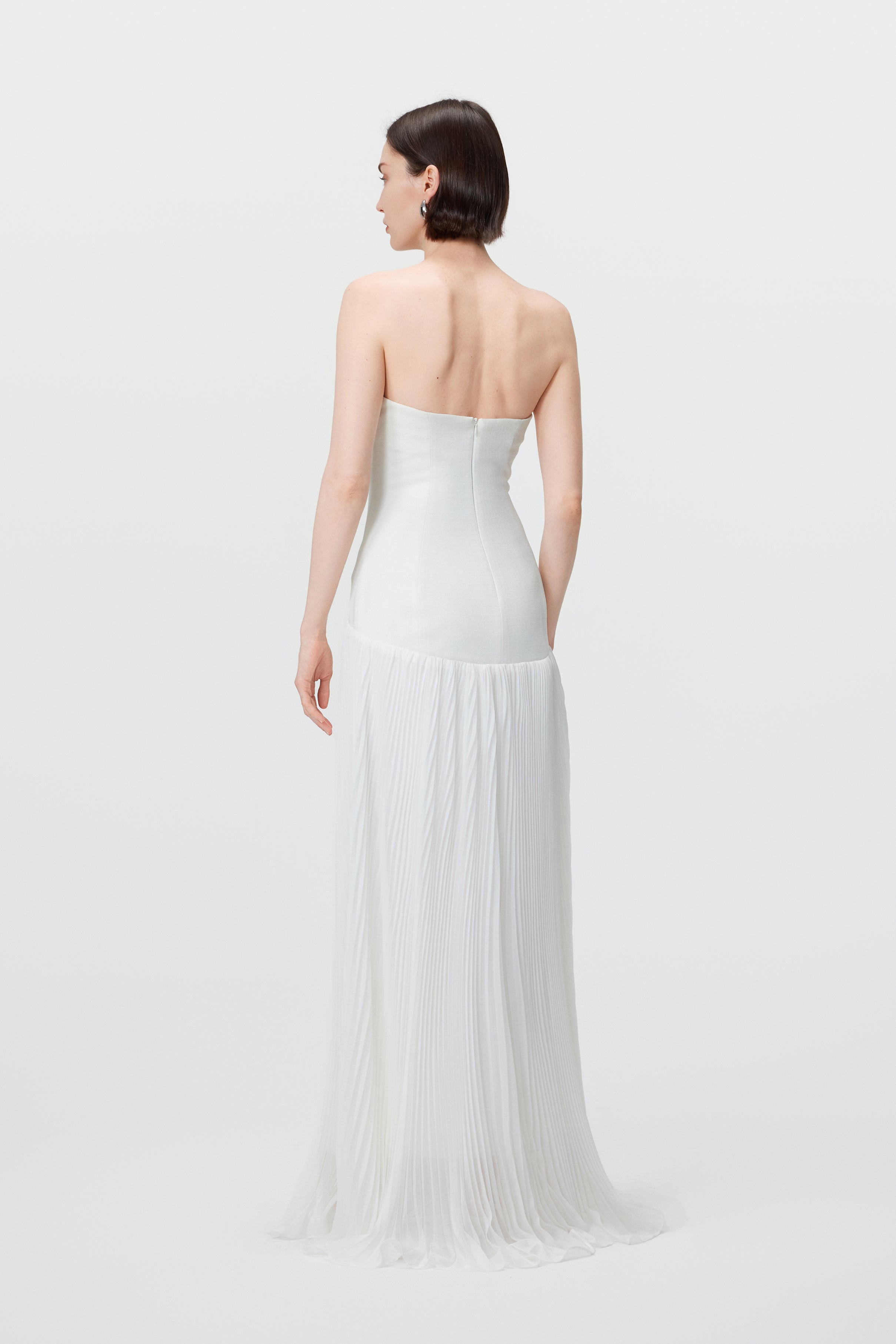 Back view of the Luna gown in Optic White, highlighting the clean, refined profile and the secure invisible zipper closure.