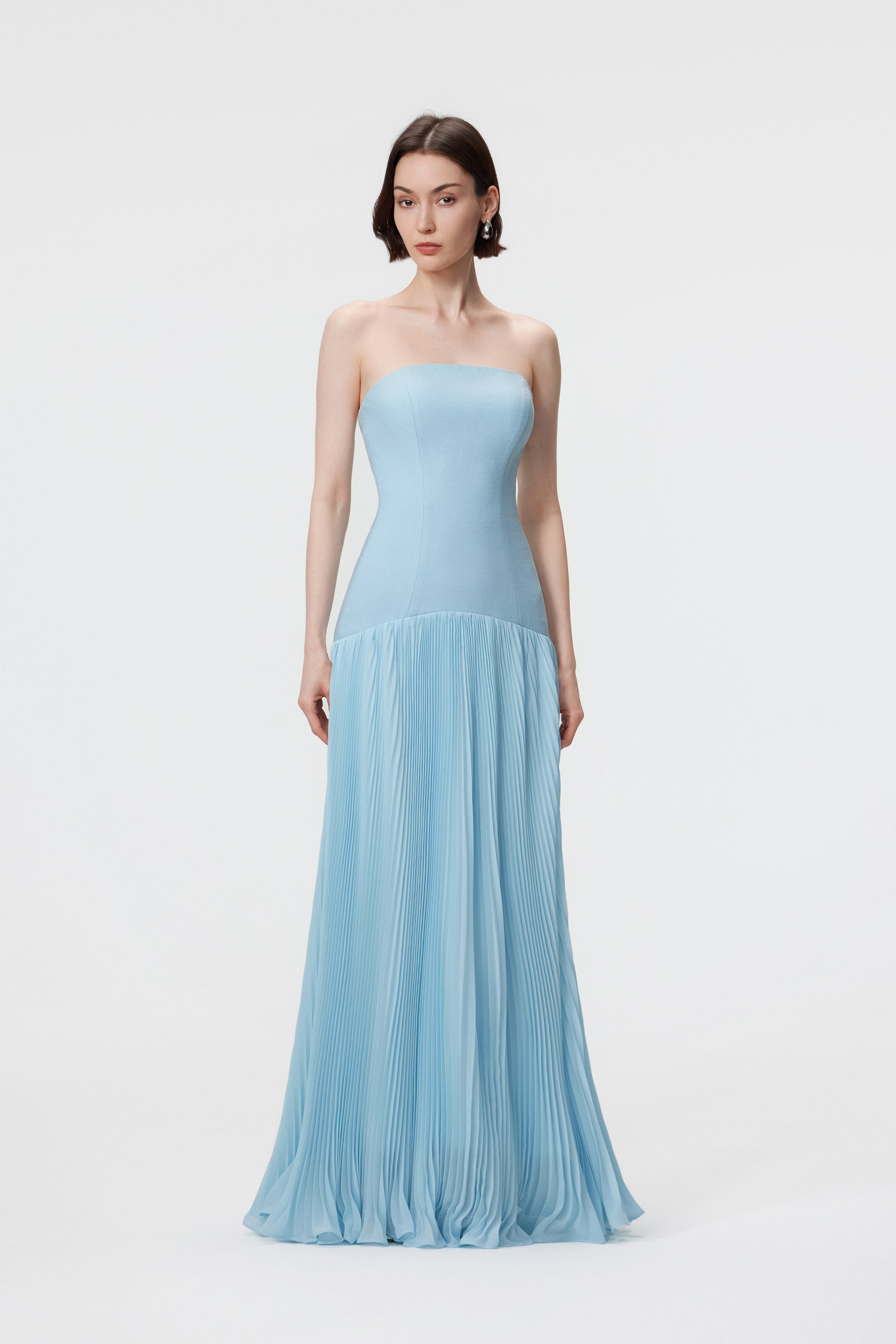 Aenso Luna Gown in Ether Blue featuring a strapless curved neckline, structured bustier bodice, and voluminous floor-length sunray pleats in specialized slubbed Naia™ acetate.