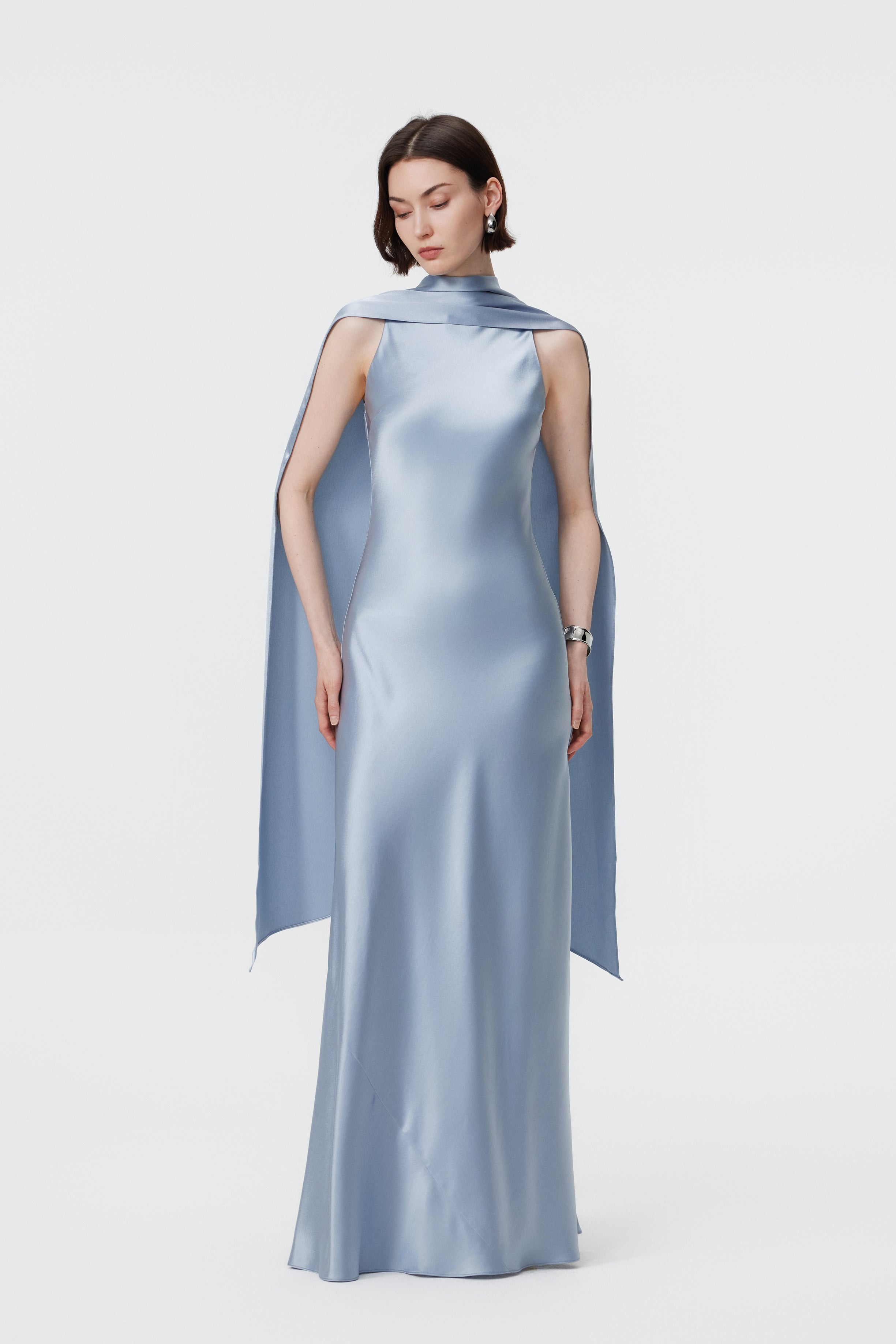 Front view of the AENSO Elara gown in Dove Blue; emphasizing the sculptural depth of the multi-way integrated scarf and the commanding, high-neck profile that defines this modern essential.