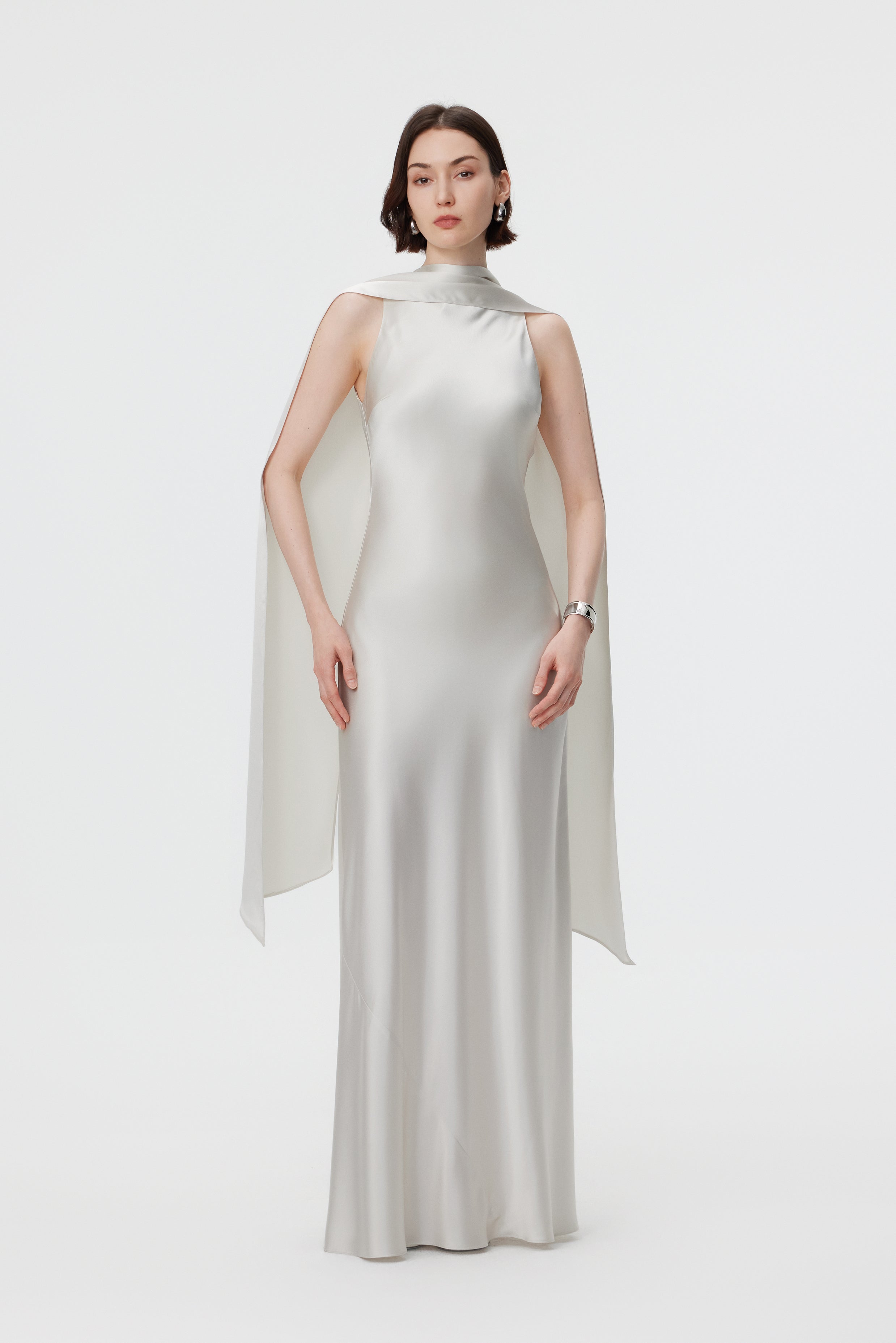 Static front view of the AENSO Elara gown in Pearl; a statuesque high-volume silhouette in radiant Naia™ Acetate featuring a commanding multi-way integrated scarf neckline.