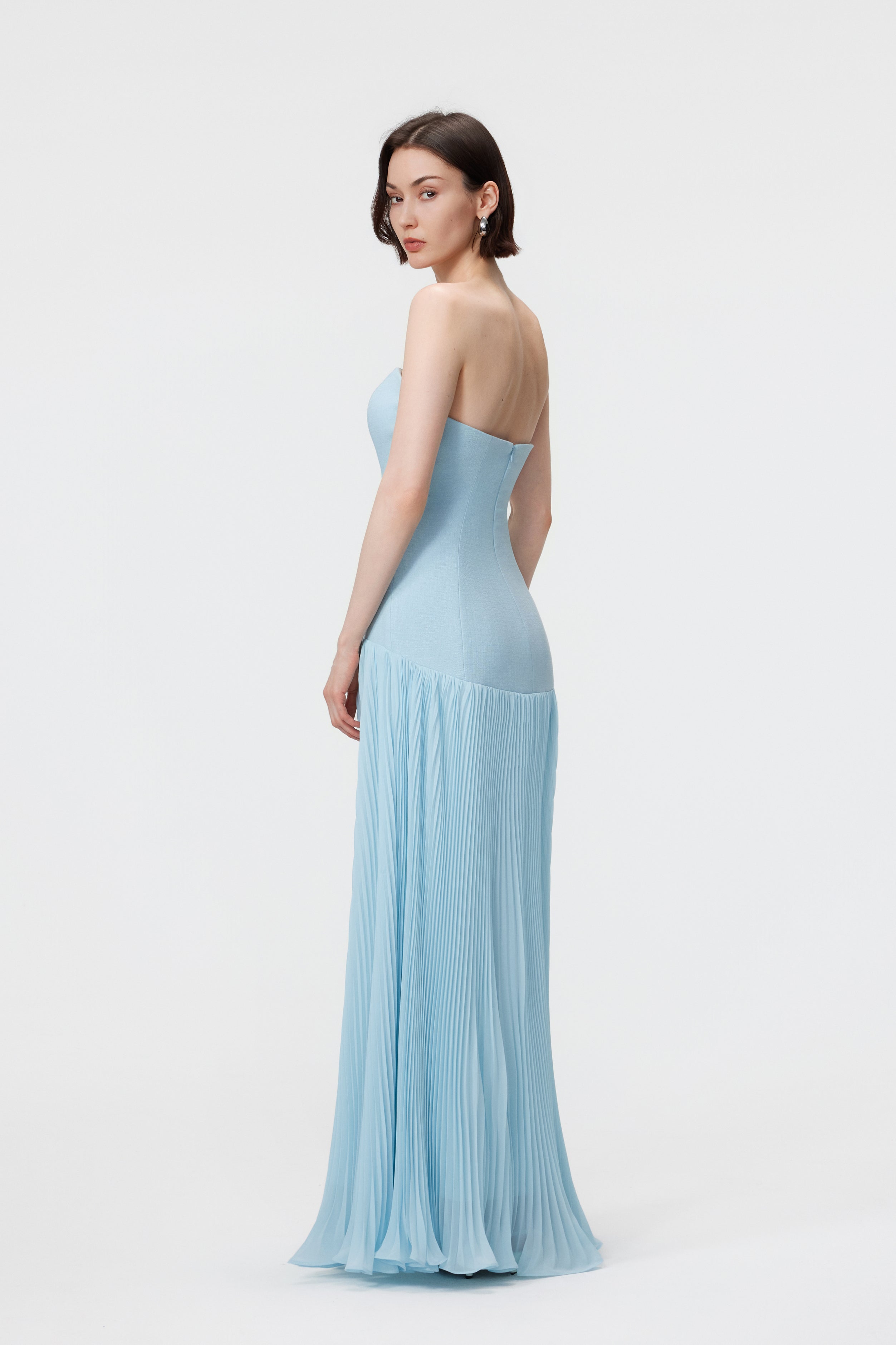 Back view of the Luna Gown in Ether Blue highlighting the seamless invisible center-back zip closure and the precision-structured bustier bodice.