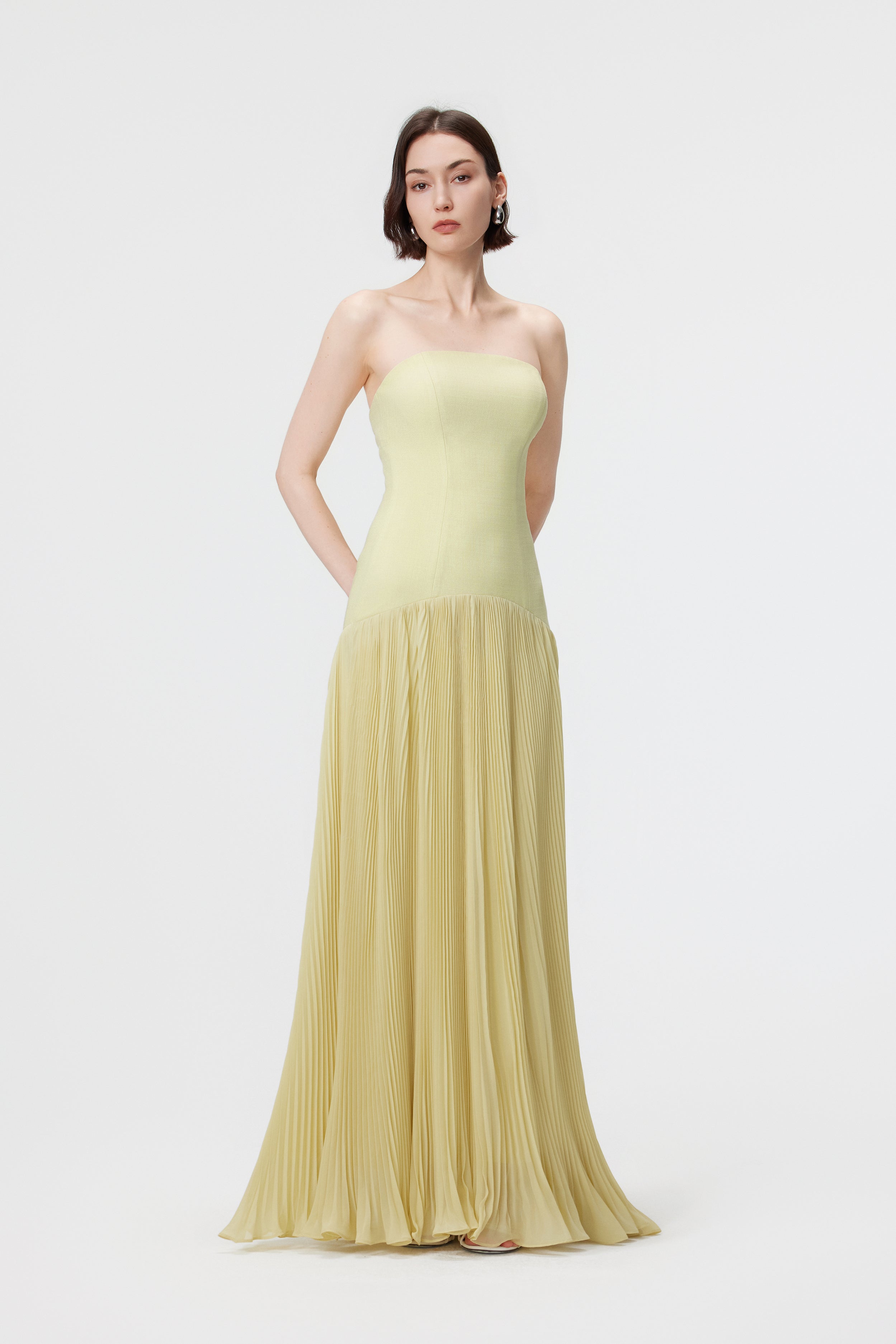 The AENSO Luna gown in Citron; a detailed look at the precision-paneled bodice and the organic, slubbed texture of the luminous yellow-green fabric.