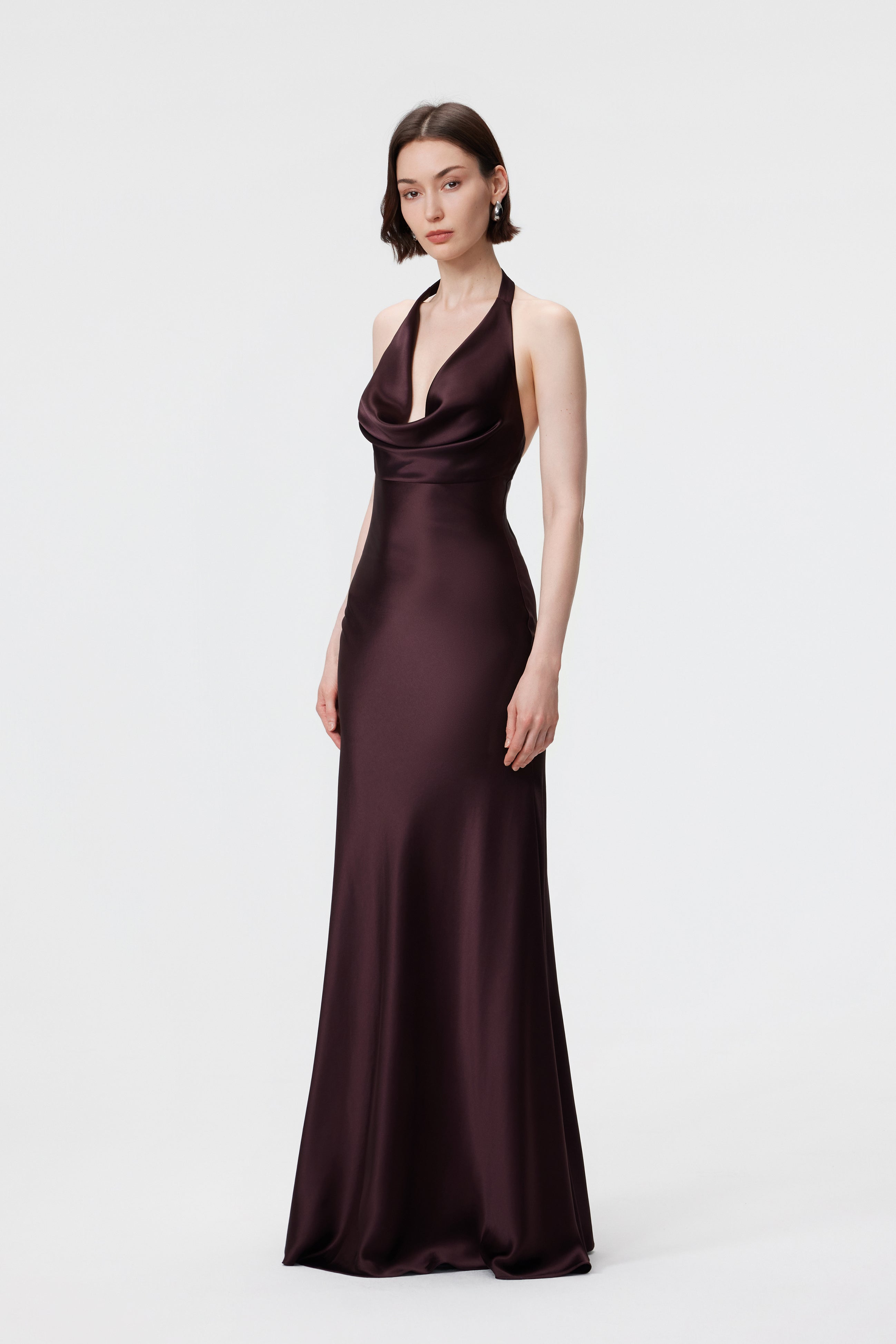 Rhea Halter Gown in Espresso, showcasing the rhythmic movement and weighted drape of the bias-cut satin.