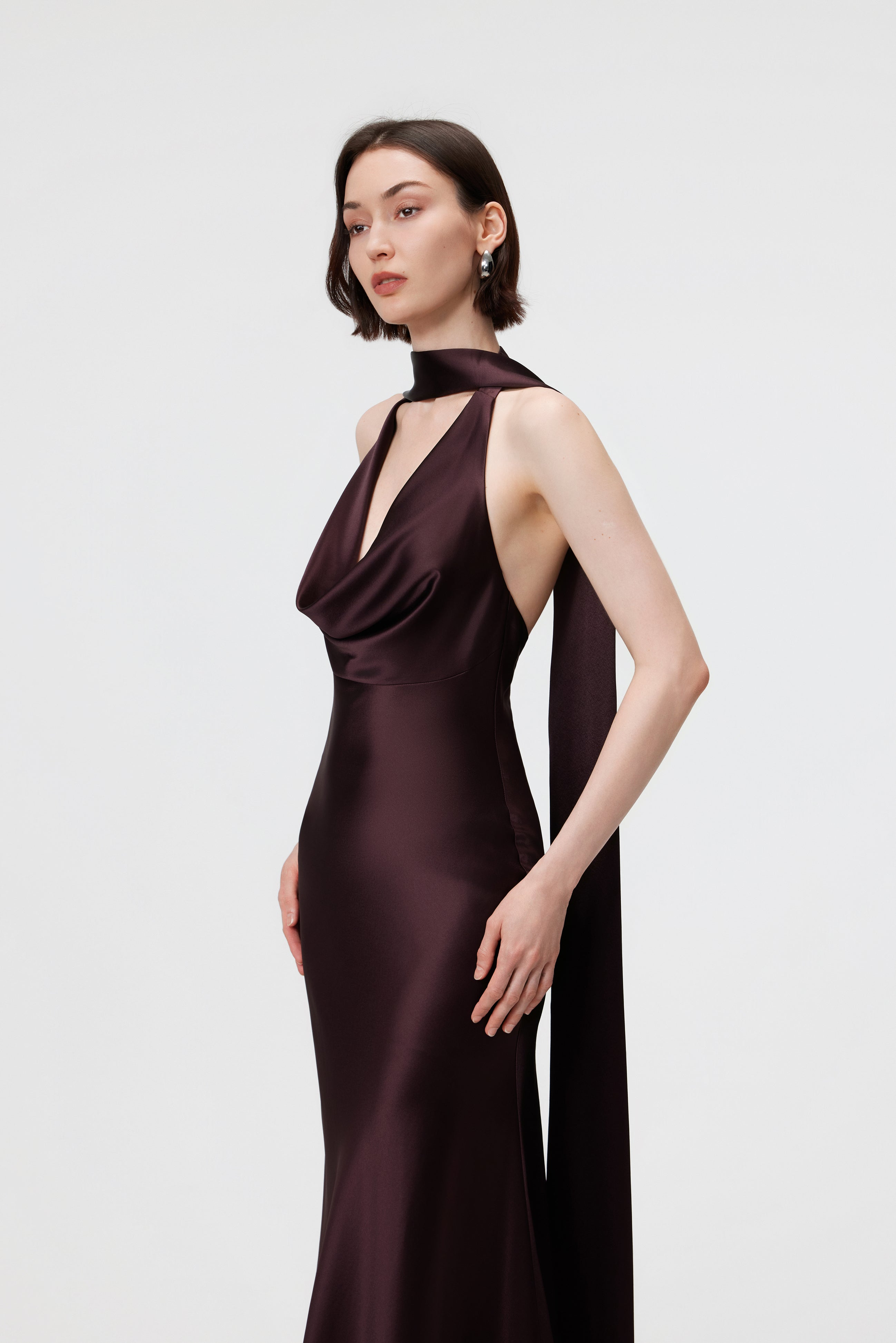 Close-up of the AENSO Rhea Gown in Espresso; showcasing the rich pigment depth and luminous finish of the artisanal Naia™ Acetate.