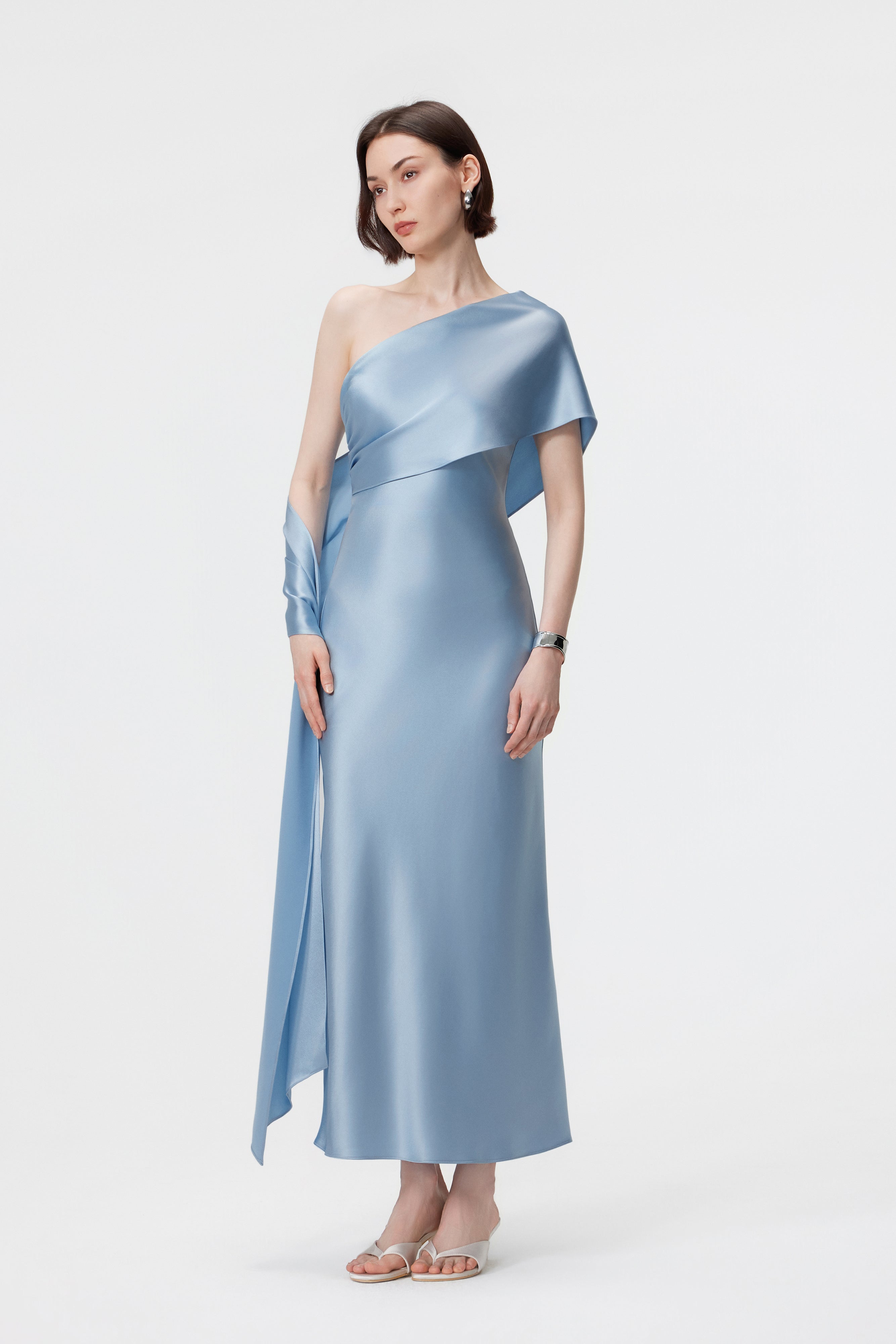 Side profile of the Lyra dress in Glacial Mist; showcasing the liquid-satin drape and the trailing hand-held scarf.